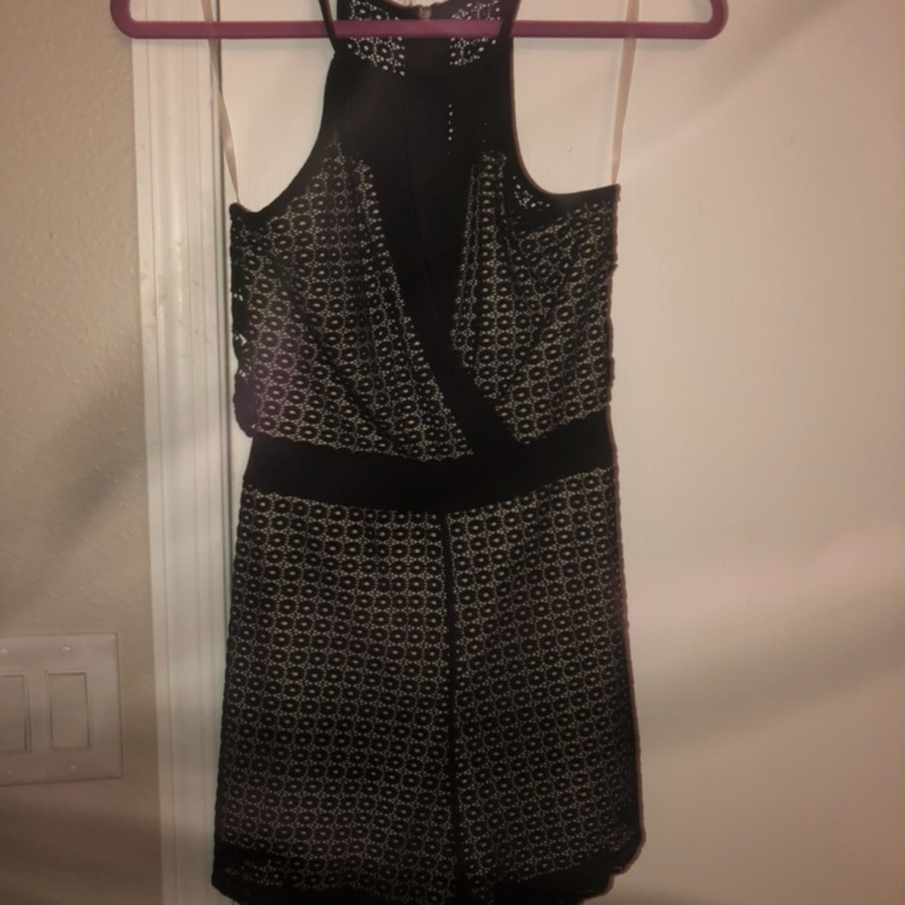 Black romper with a nude slip and detailed back